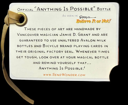 Label for 'Anything Is Possible' bottle with text and a strap on a black background