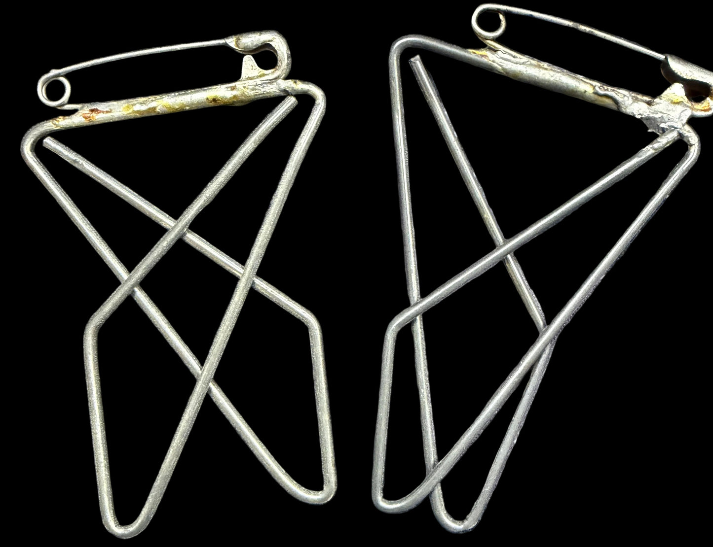 Pair of geometric earrings on a world map background