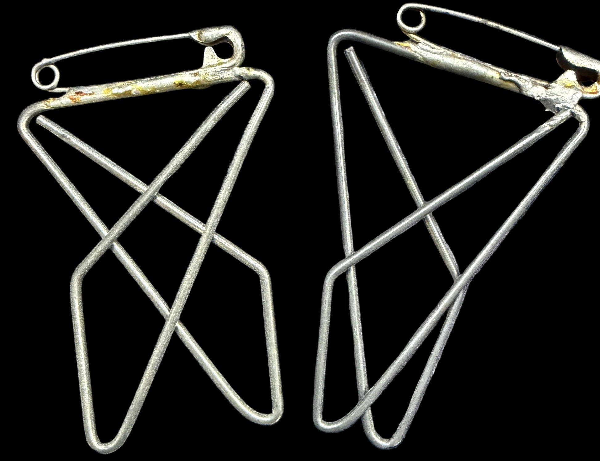 Pair of geometric earrings on a world map background