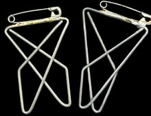 Pair of geometric earrings on a world map background