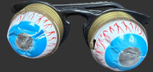 Two fishing reel spools with blue and red line on a map background