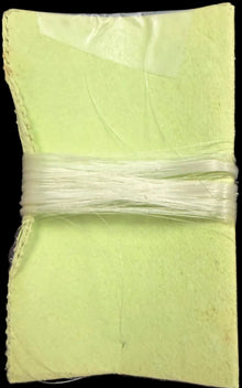 Green fabric square on a map background