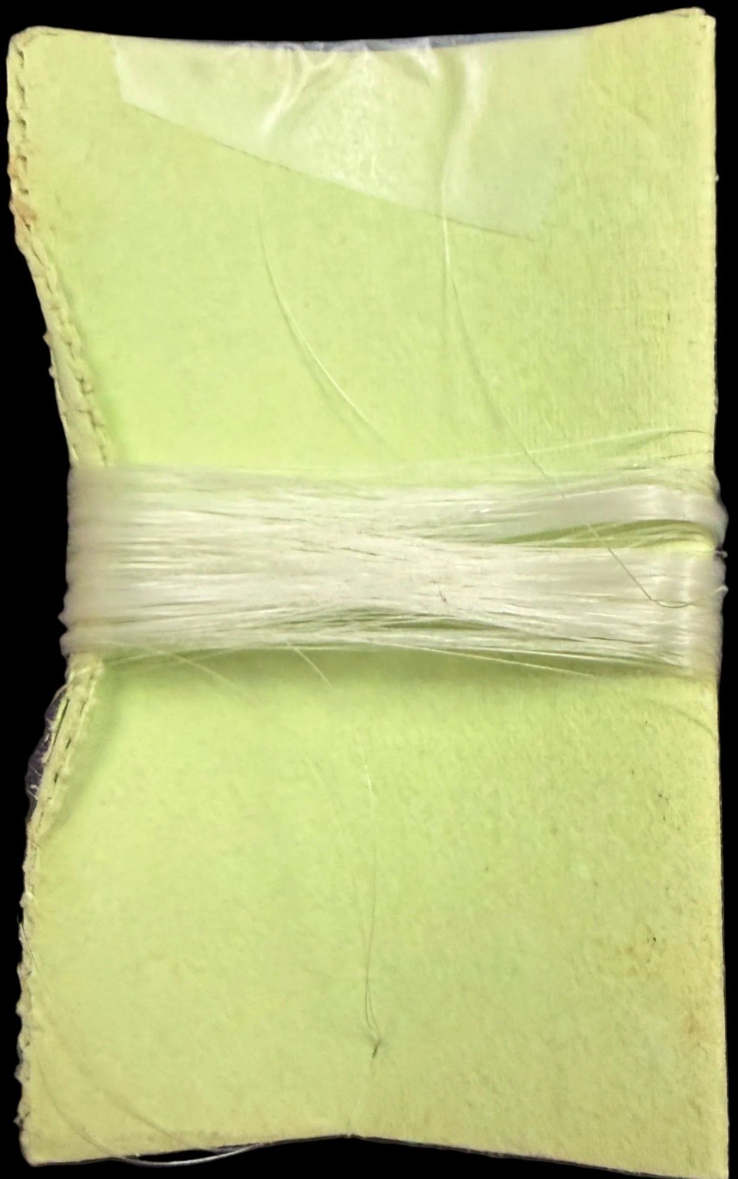 Green fabric square on a map background