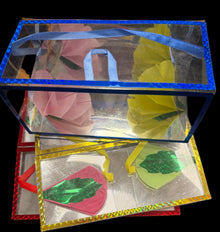 Decorative cards with colorful cut-out shapes on a dark surface