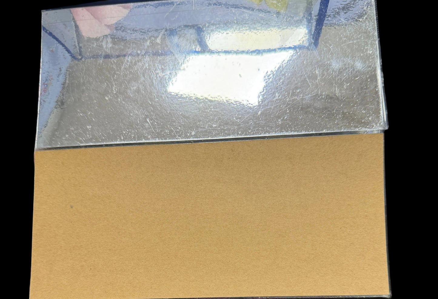 Brown paper sheet on a dark surface with a blurred background