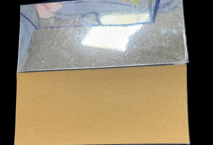 Brown paper sheet on a dark surface with a blurred background