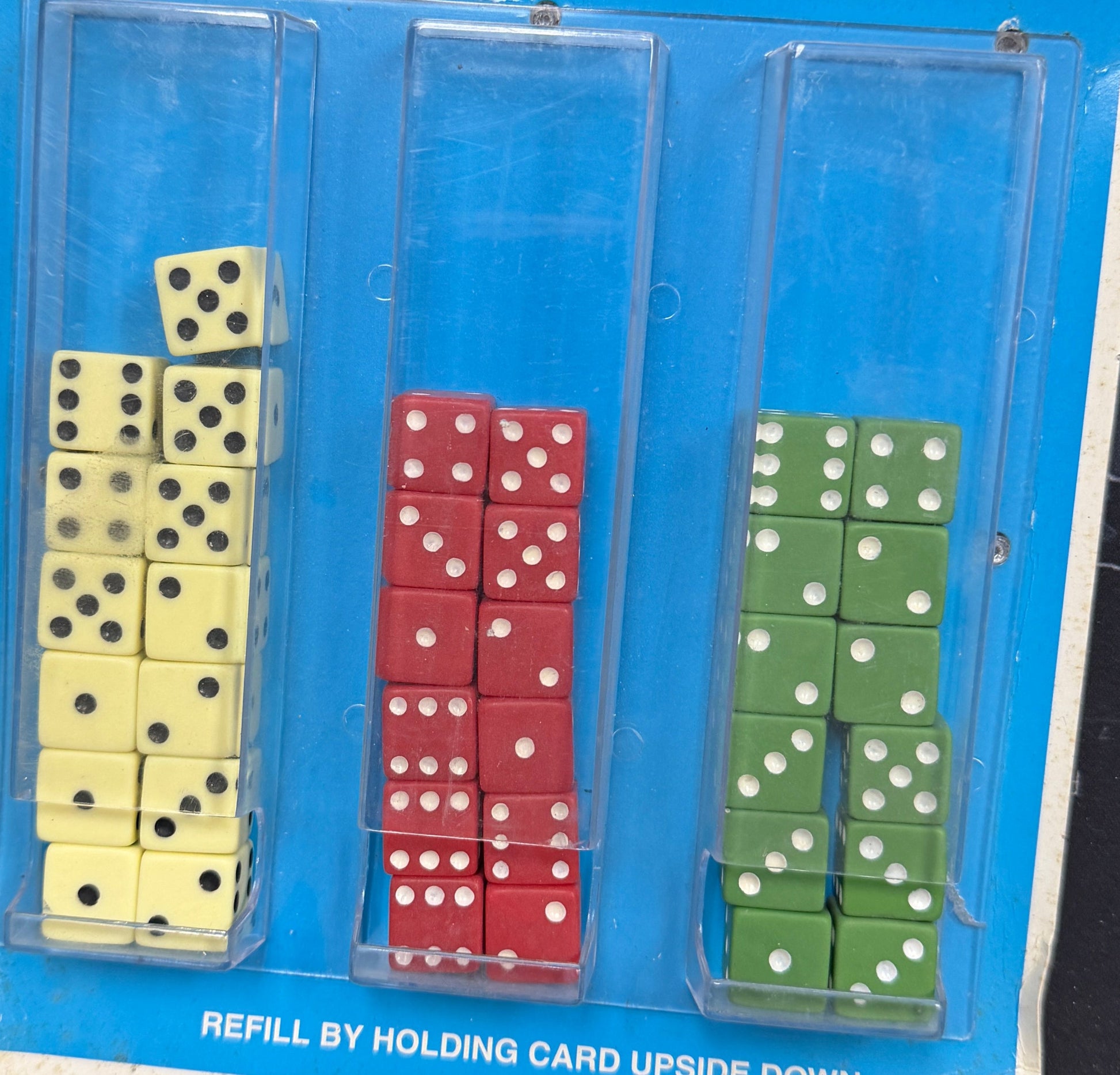 Dice set in packaging with Lucky Dice Home Games branding on a wooden surface.