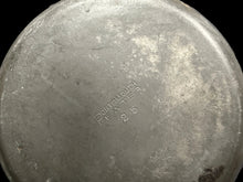 Metal container with 'Dorothy Day' branding on a blurred background