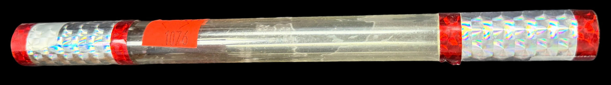 Clear cylindrical object with red and white accents on a map background