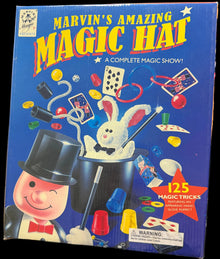 Marvin's Amazing Magic Hat box on a table with electronic equipment in the background