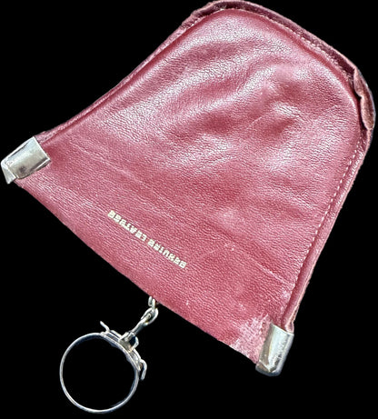 Pink leather pouch with keychain on a world map background