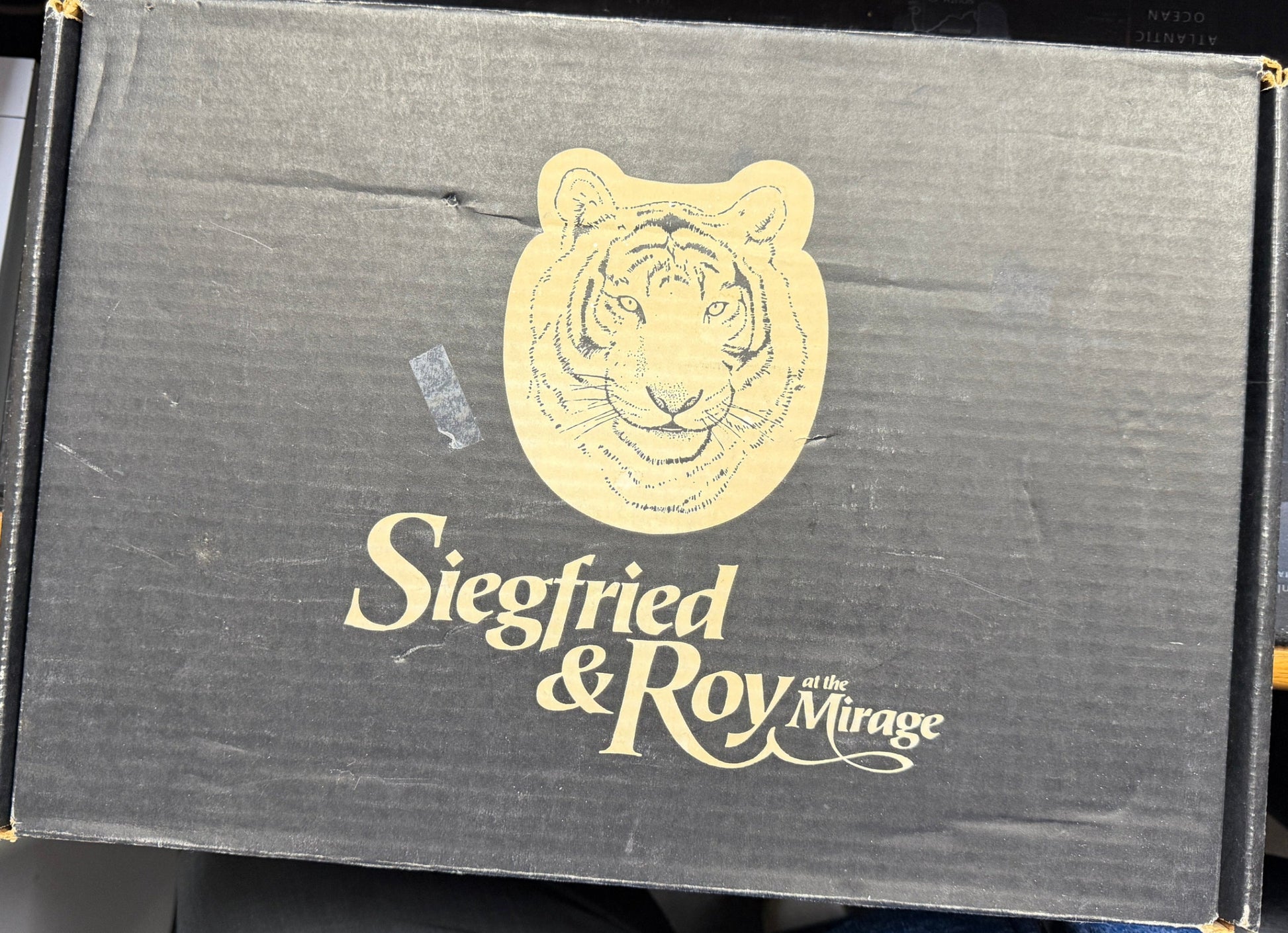Siegfried & Roy Mirage logo on a black box with a tiger emblem.