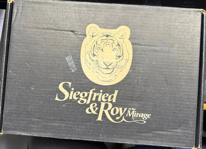 Siegfried & Roy Mirage logo on a black box with a tiger emblem.