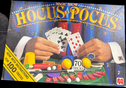 Hocus Pocus magic show book with illustrations of hands performing tricks on a table.