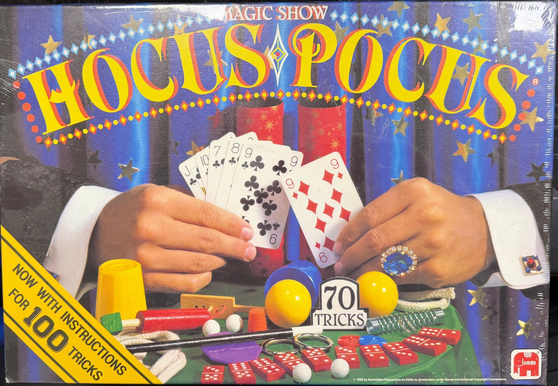 Hocus Pocus magic show kit packaging with hands holding playing cards and magic props.