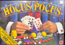 Hocus Pocus magic show kit packaging with hands holding playing cards and magic props.