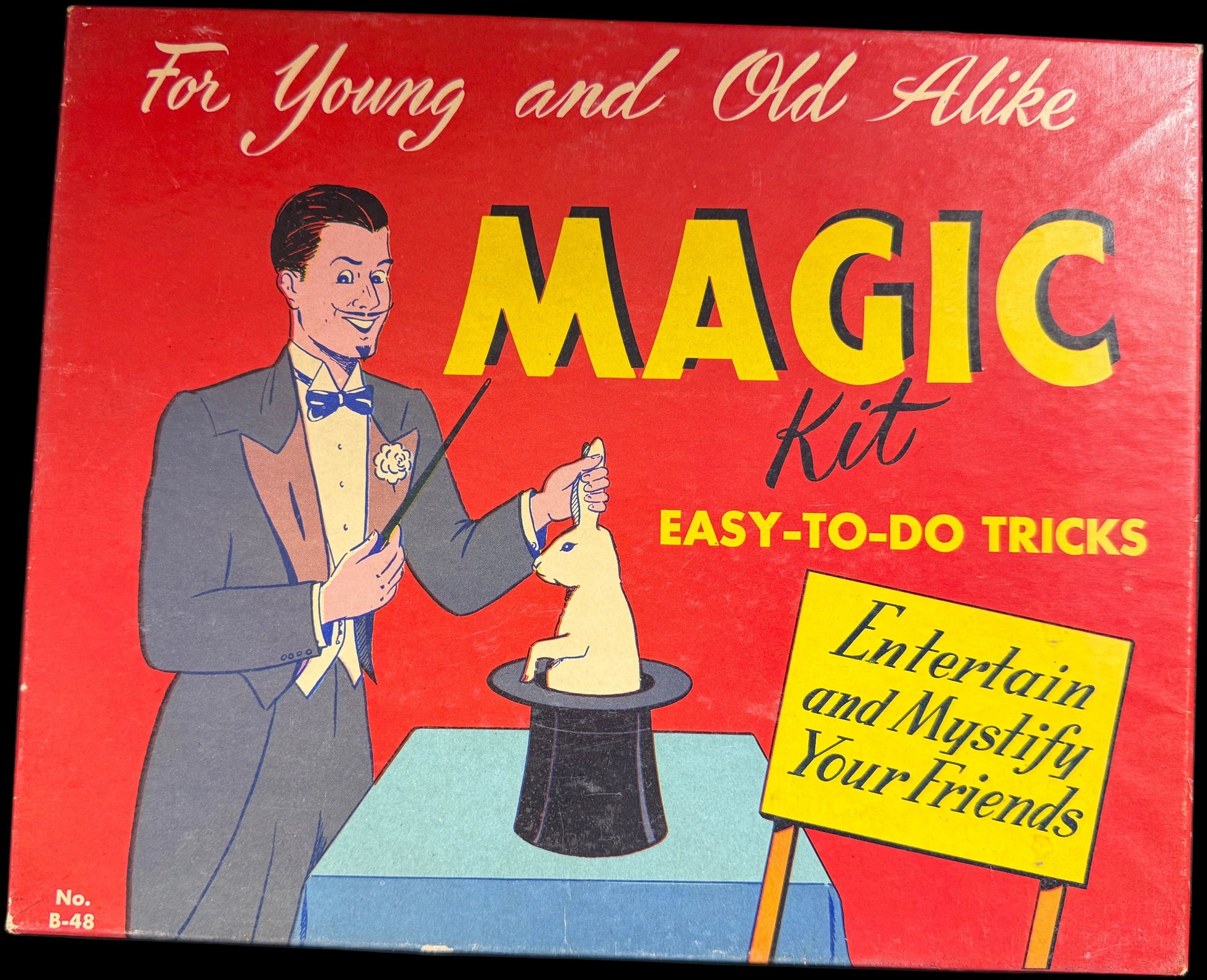 Vintage Magic Kit packaging with a magician illustration on a red background