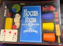 Hocus Pocus magic show kit with cards and cups on a table.