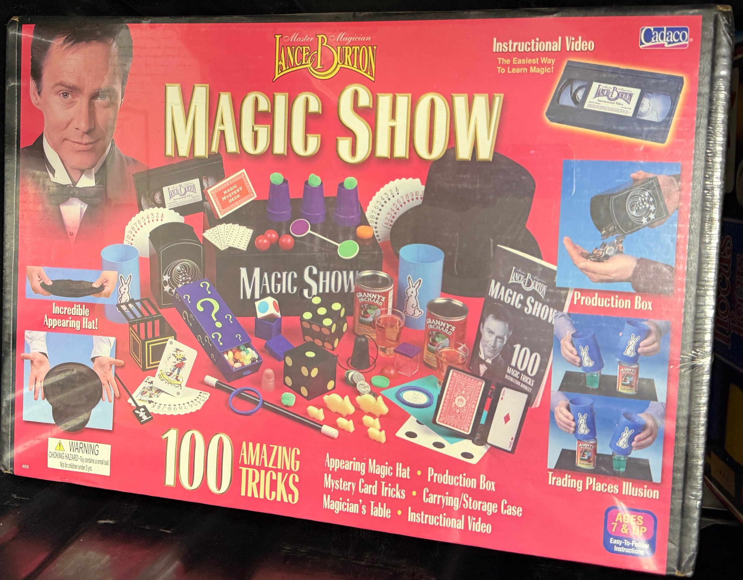 Vintage Magic Show book with colorful illustrations on a dark surface
