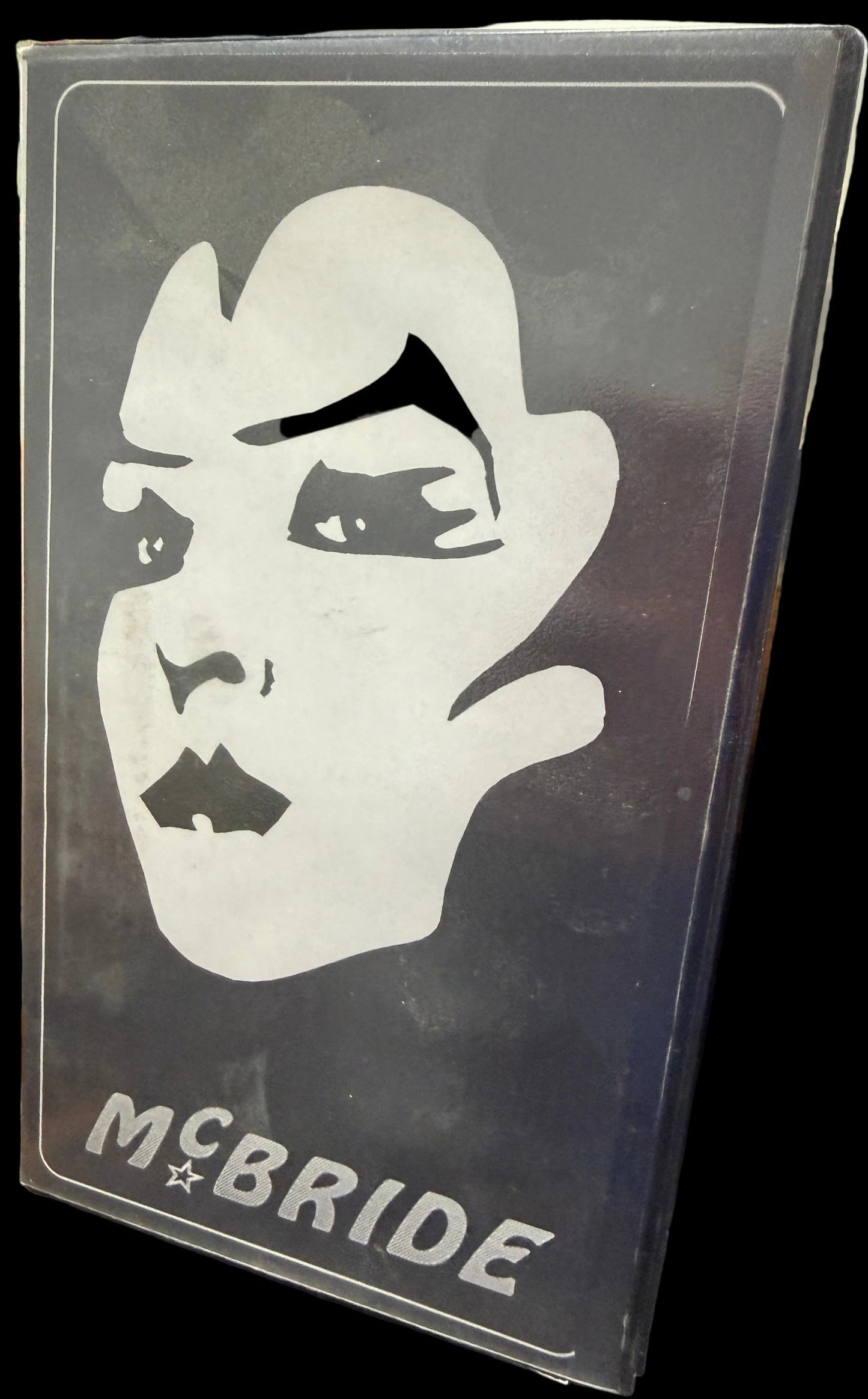 Sticker with a logo and 'McBride' text on a dark surface