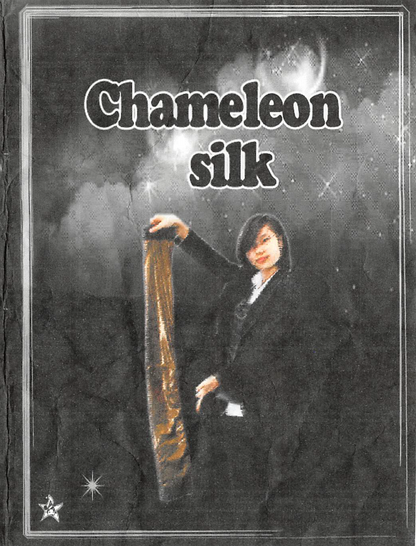 Person holding a long, thin object with 'Chameleon silk' text on a dark background