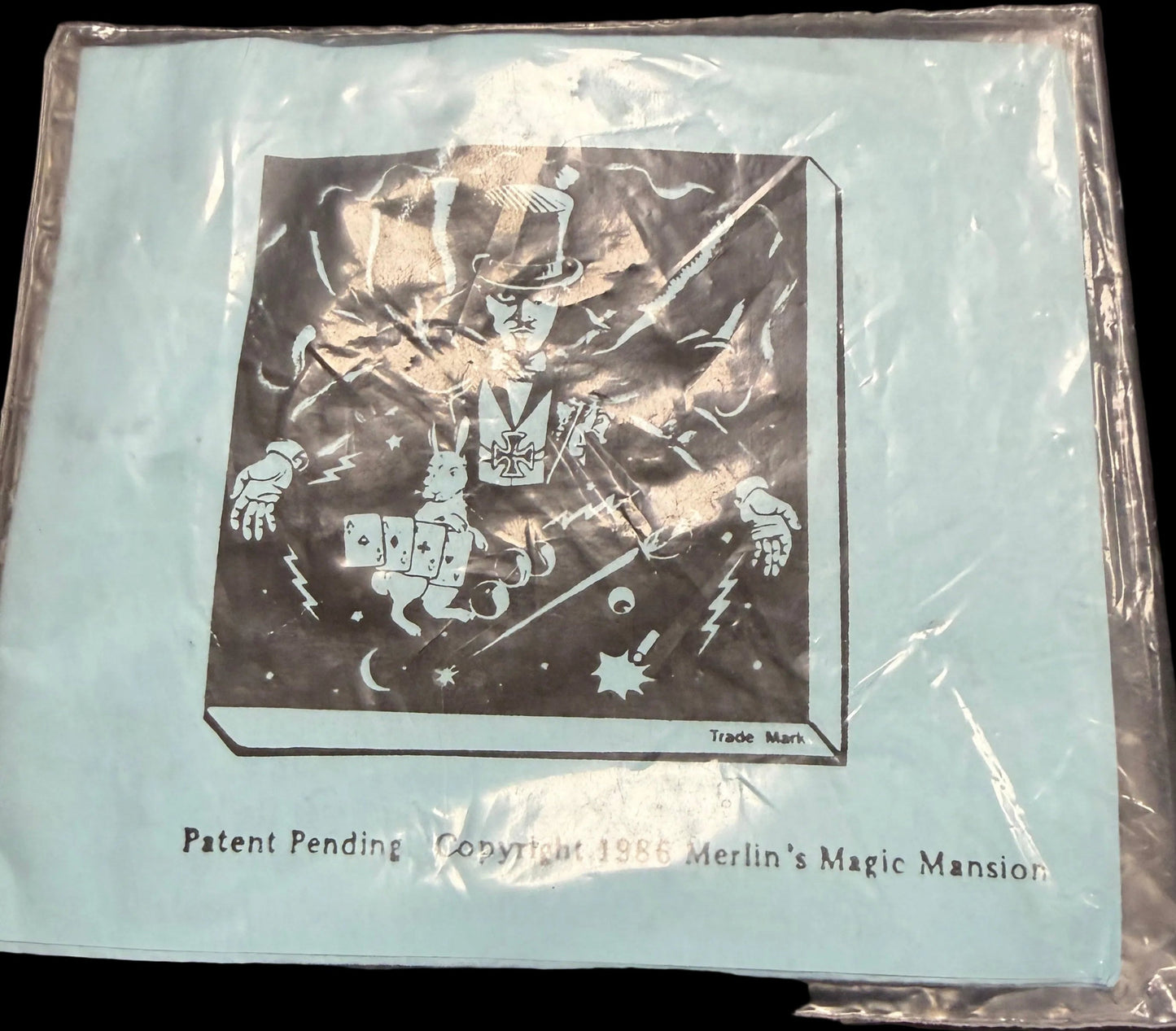 Card in clear plastic packaging on a dark surface with star patterns