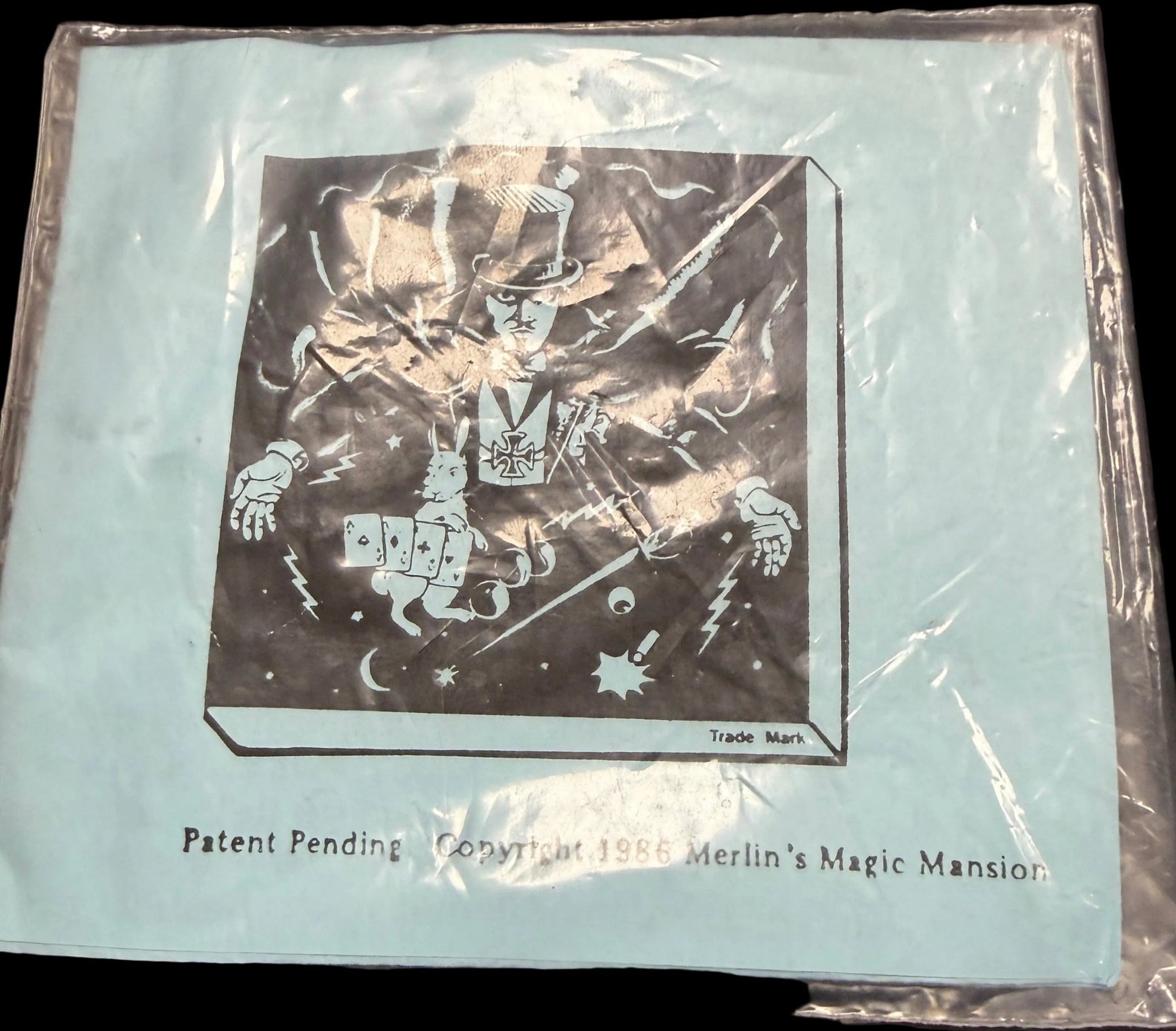 Card in clear plastic packaging on a dark surface with star patterns