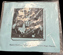 Card in clear plastic packaging on a dark surface with star patterns