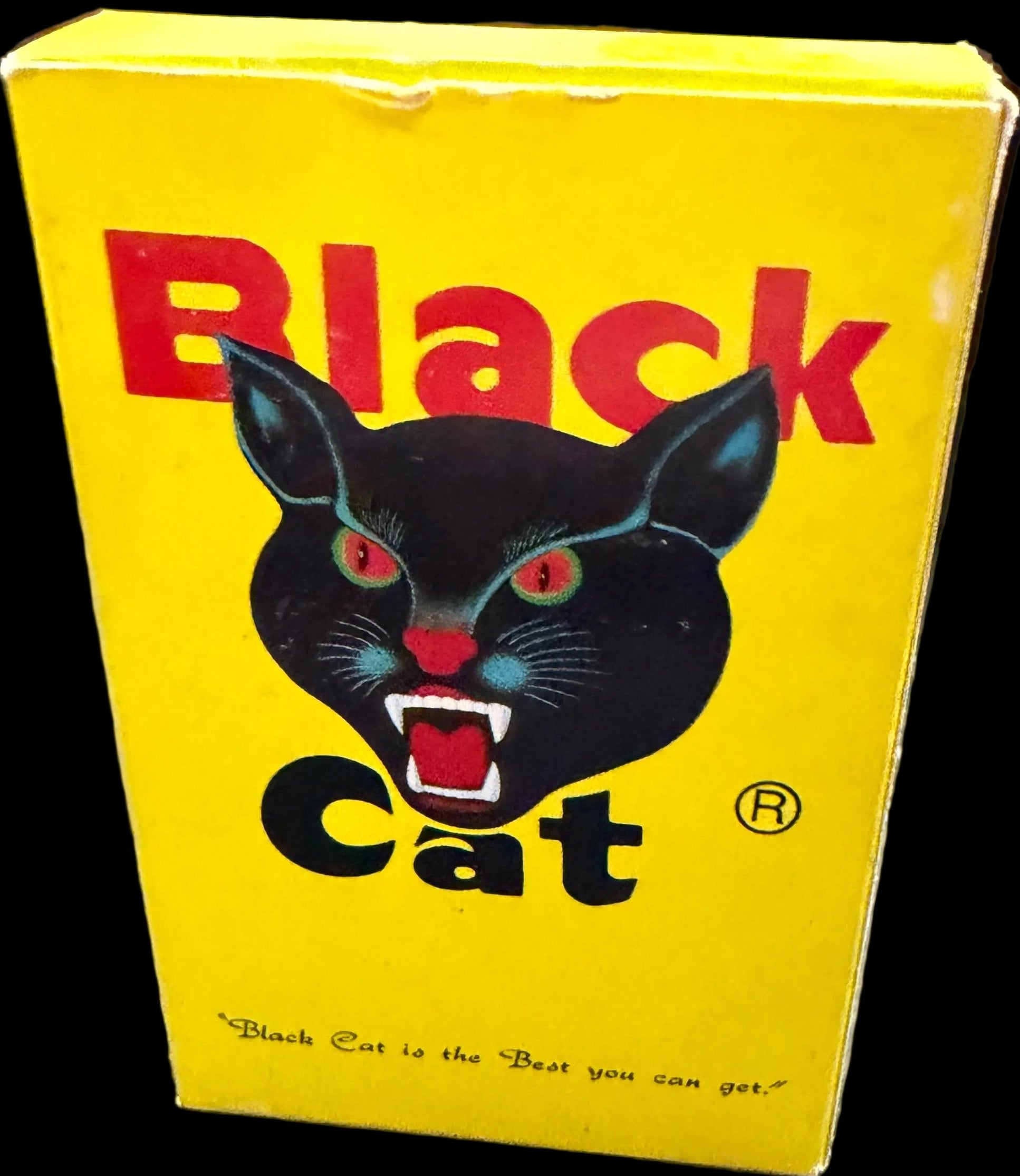 Yellow book titled 'Black Cat' with a black cat illustration on a world map background