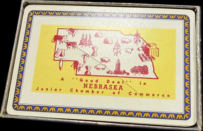 Playing card box with a yellow label on a world map background