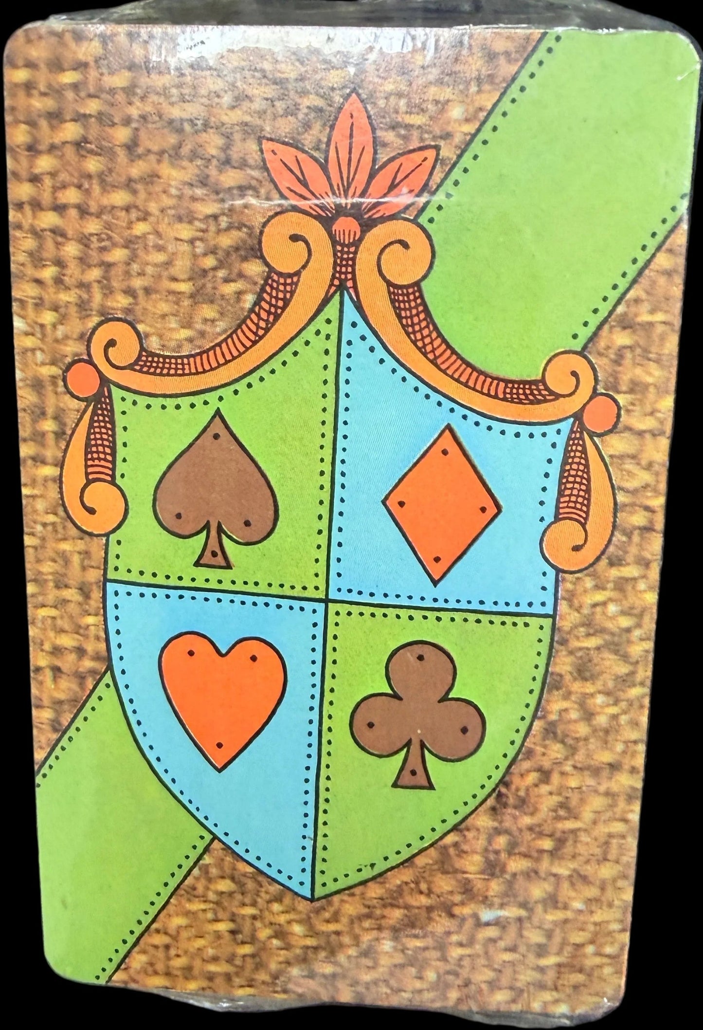 Decorative card with playing card suits on a dark surface