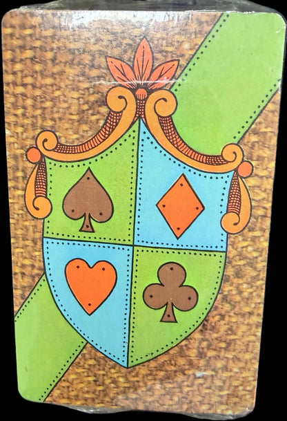 Decorative card with playing card suits on a dark surface