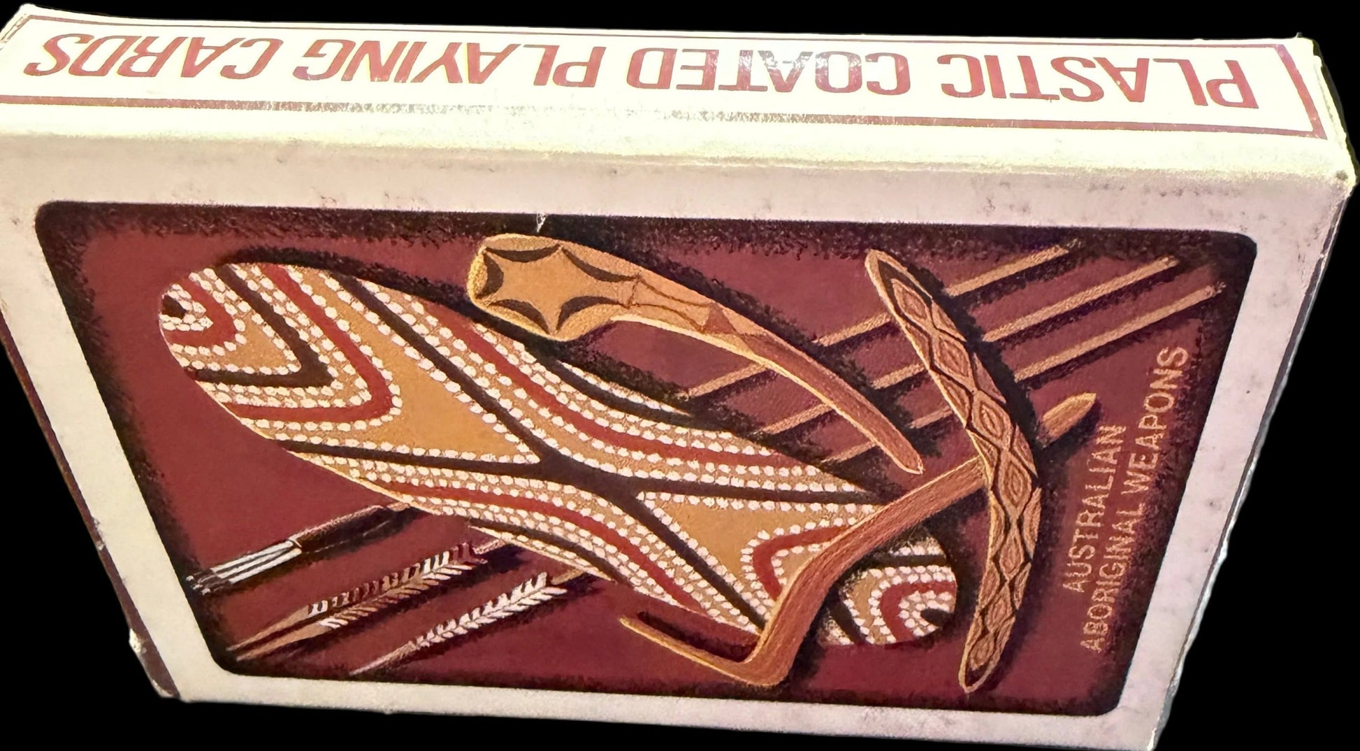 Playing card box with tribal design on a map background