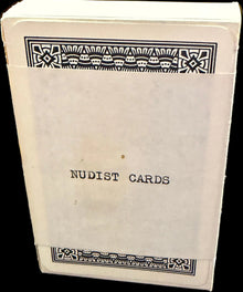 Book titled 'Nudist Caribs' on a wooden surface with a map in the background