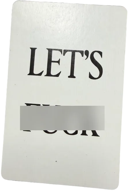 White card with 'LET'S' printed on it against a dark background