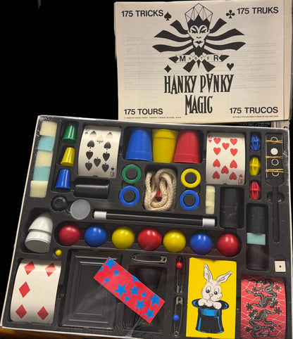 Hanky Dandy Magic kit with various magic props on a desk.