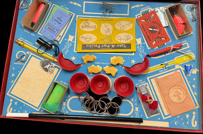 Collection of vintage tools and items on a blue tray with a wooden surface underneath.