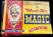 Vintage 'Royal Wonder Box Magic' box with colorful design on a wooden surface.