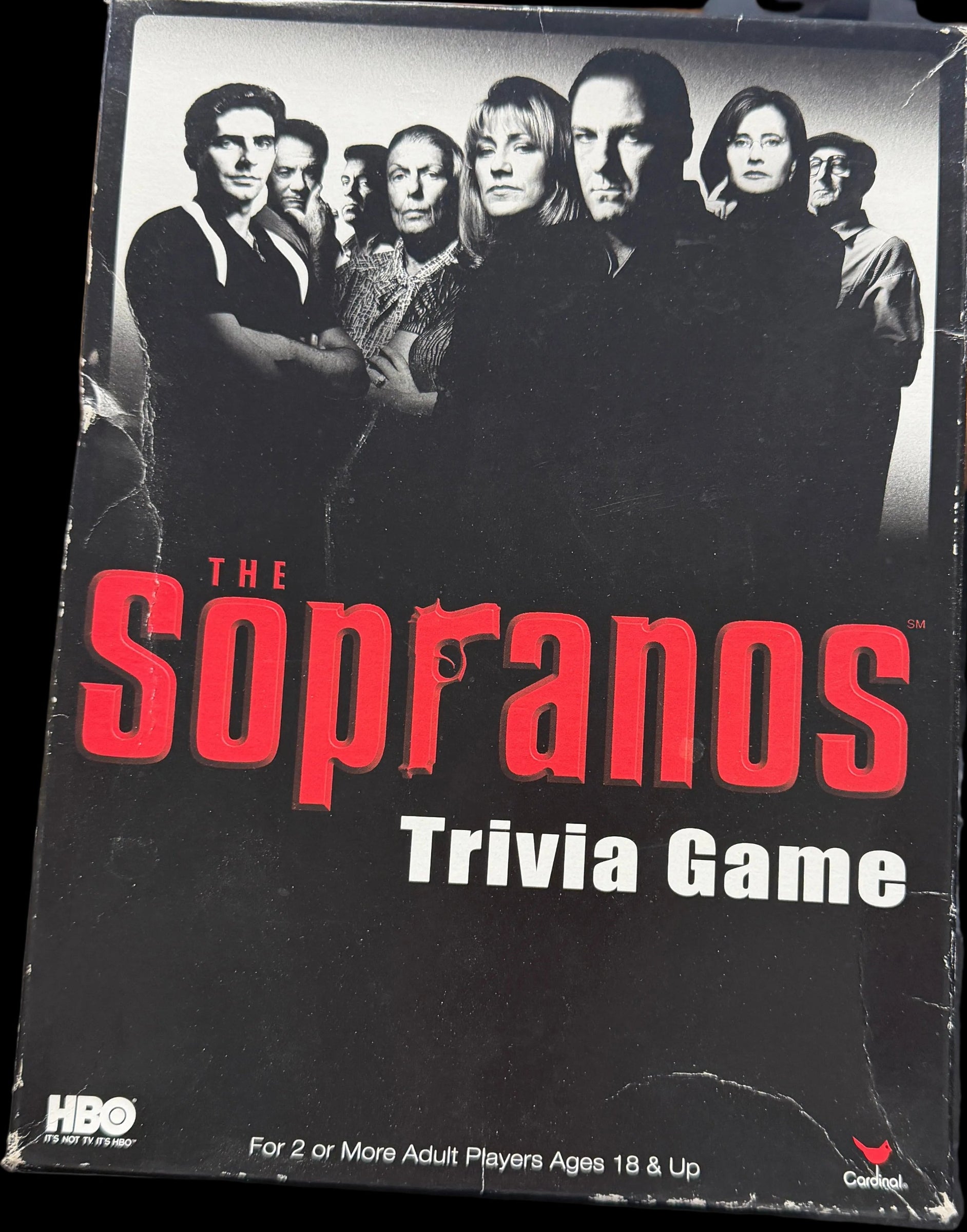 Sopranos trivia game box on a table with various items in the background
