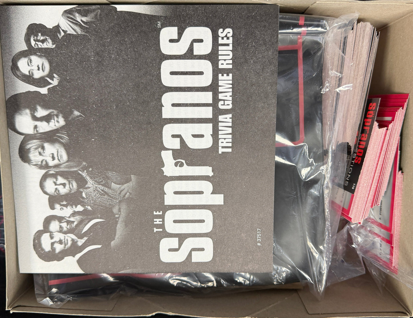 Trivial game rules book titled 'The Sopranos' in a box with plastic packaging.