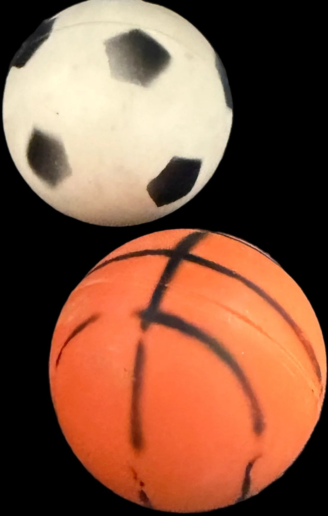 Two balls, one white and one orange with black patterns, on a world map background.
