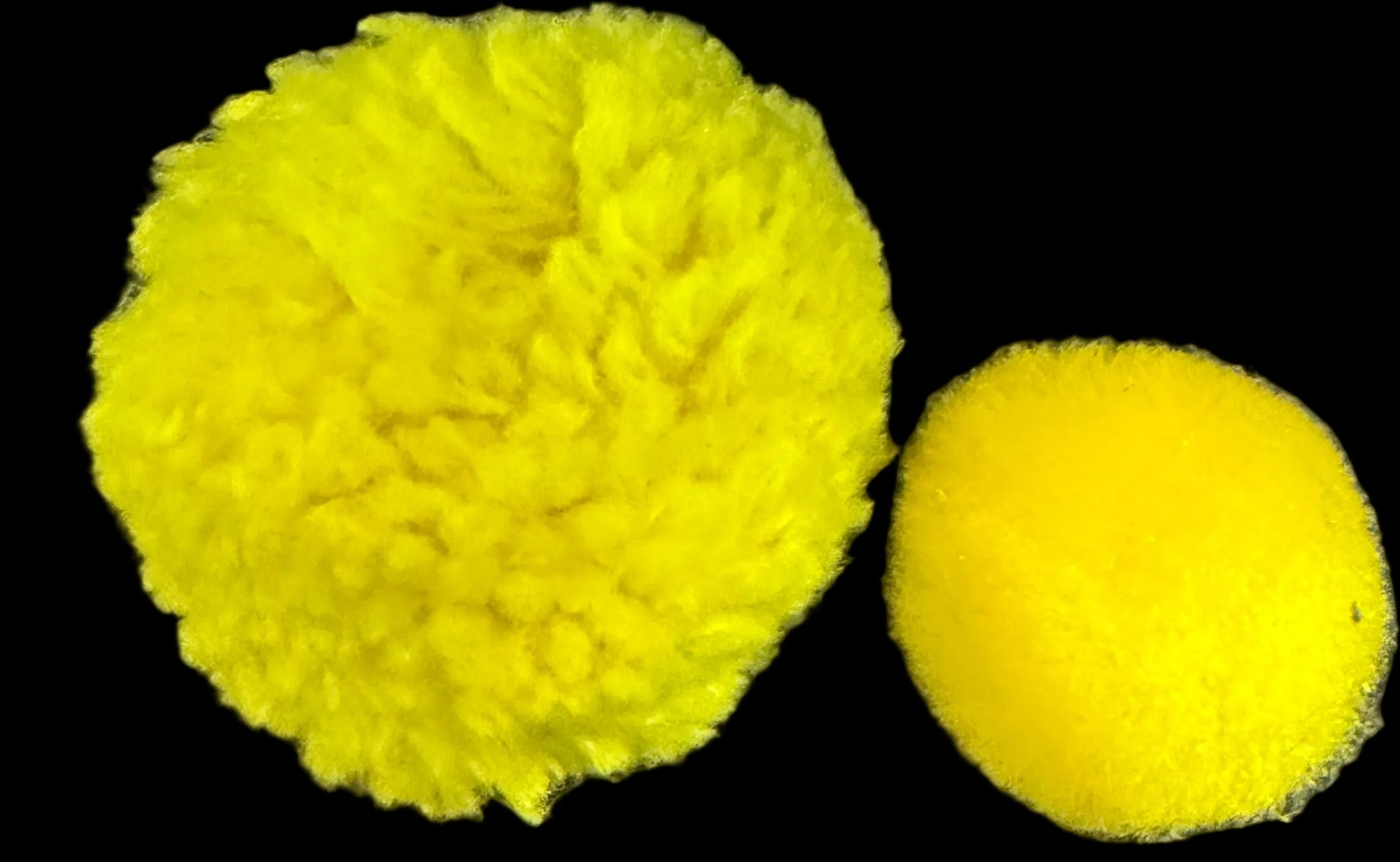 Two yellow pom-poms on a world map