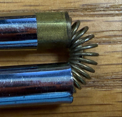 Two metal tools on a wooden surface