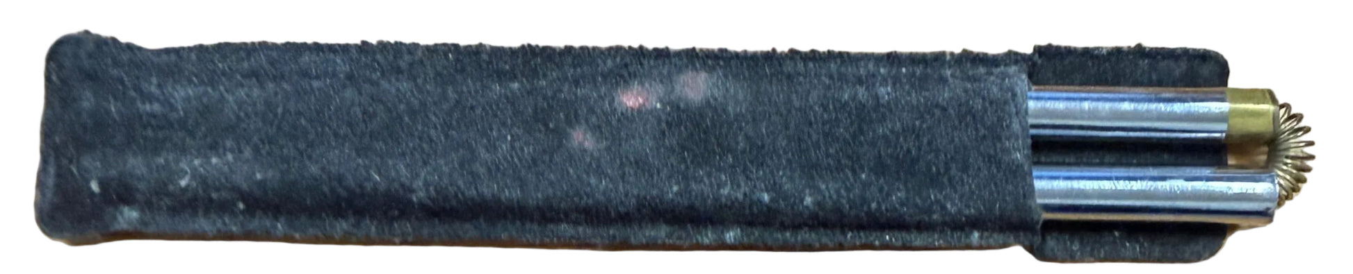 Black pepper spray canister on a wooden surface next to a keyboard