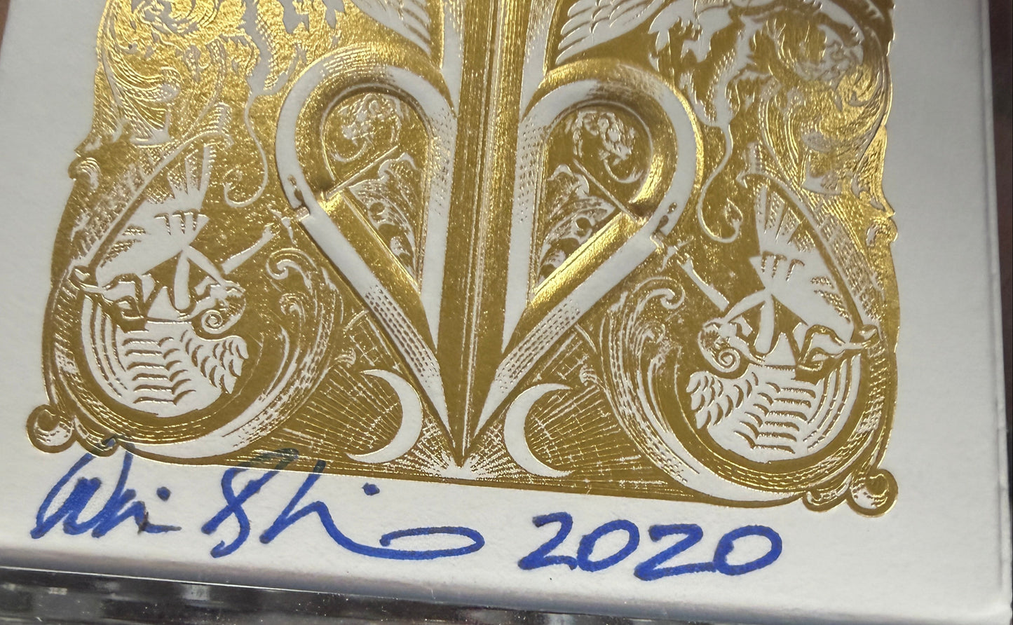Playing cards with gold design and '2020' text on a keyboard