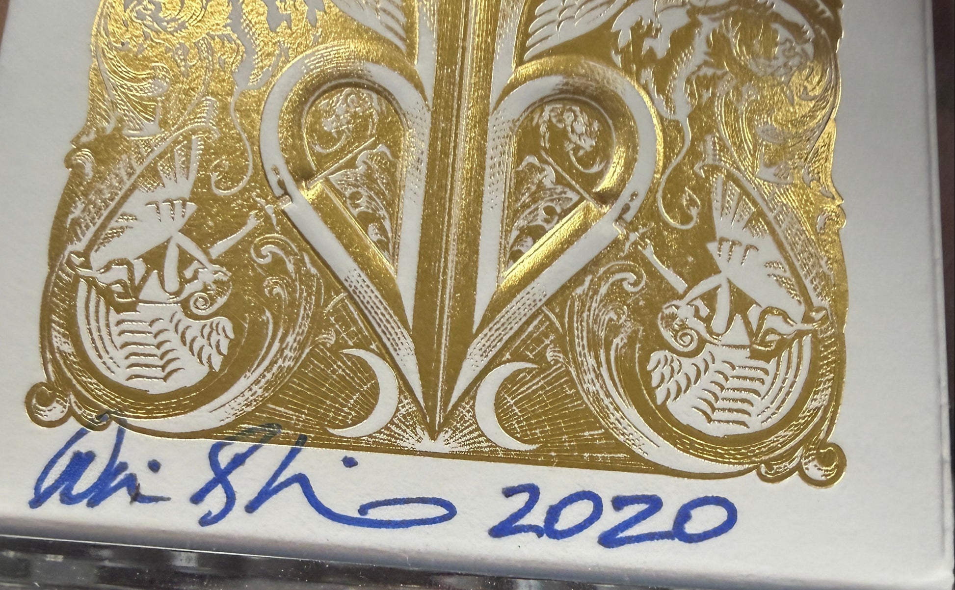 Playing cards with gold design and '2020' text on a keyboard