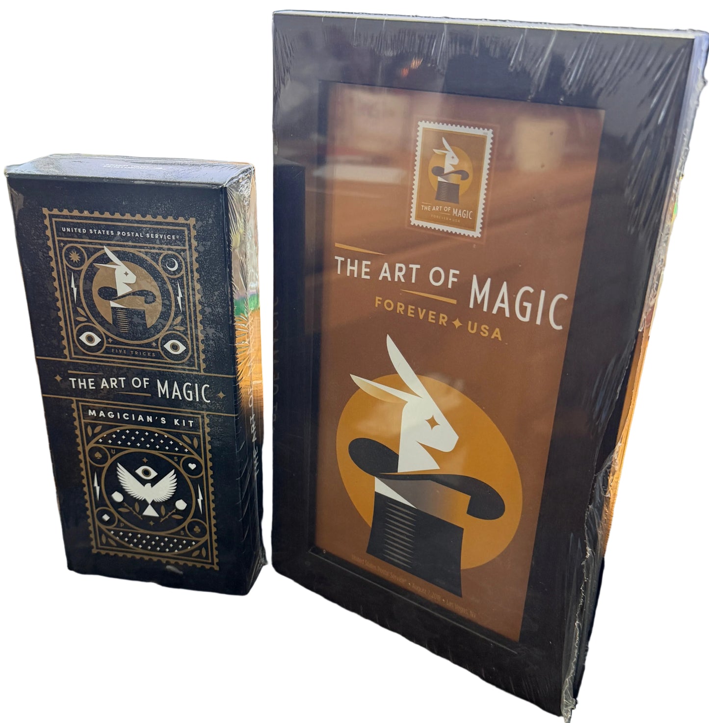 Two decks of 'The Art of Magic' playing cards on a desk with a computer monitor in the background.