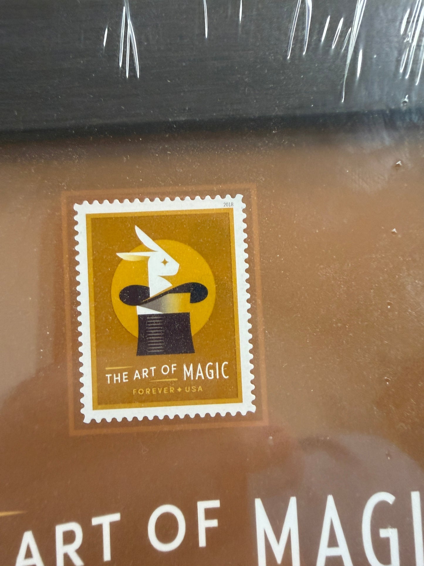 Stylized postage stamp design on a product packaging with 'The Art of Magic' branding.