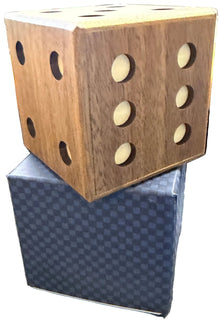 Wooden dice holder with holes on a shelf