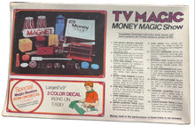 Advertisement for TV Magic Money Magic Show with product images and text on a table.